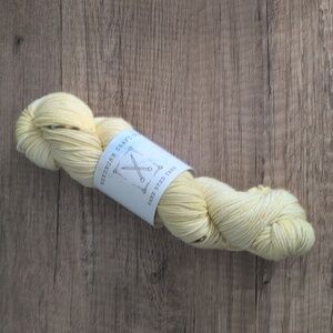 Skein of Yellow Speckled Hand Dyed DK Weight Yarn